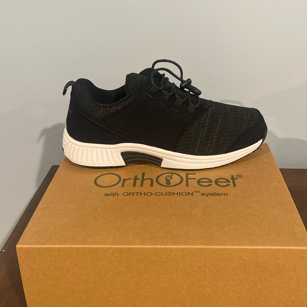 Women’s black and white orthopedic sneakers.